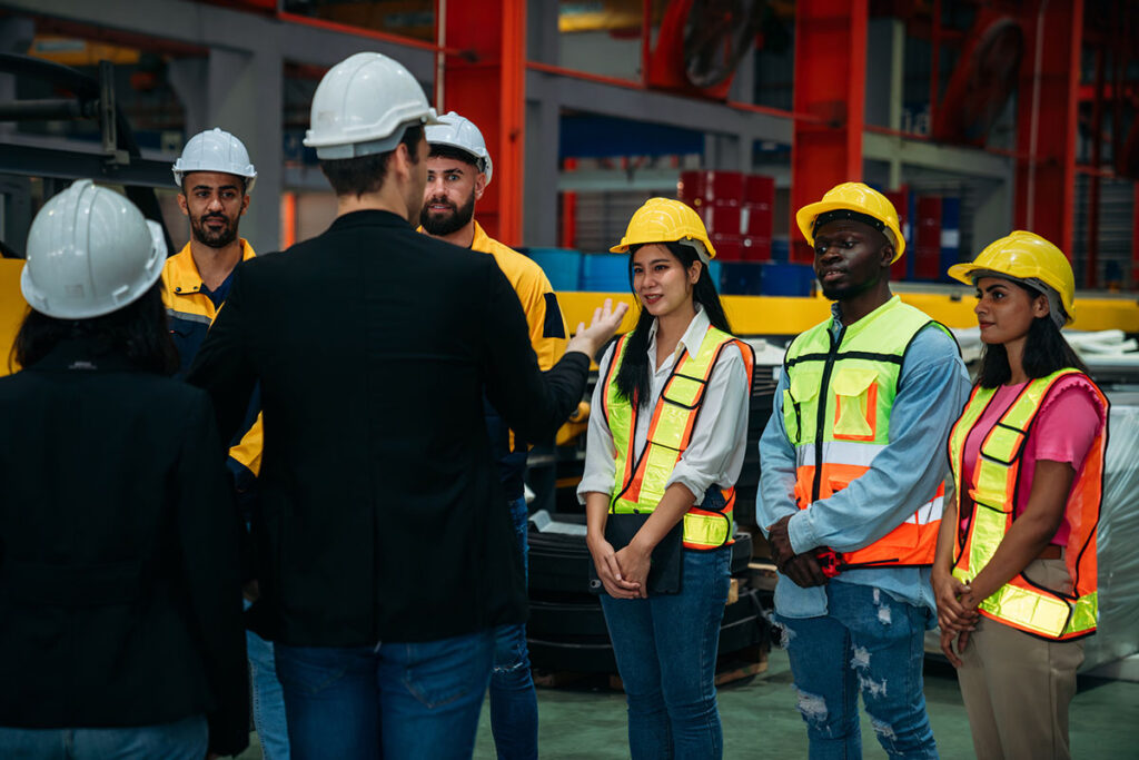 Team Engineers And Foreman Stack Hand And Shake Hands To Show Success At Factory Machines. Worker Industry Join Hand For Collaboration.