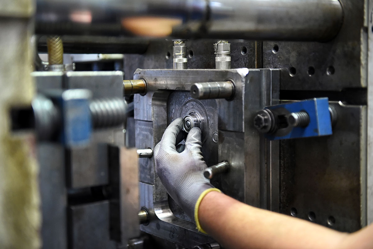 Workman Working On Large Industrial Machinery